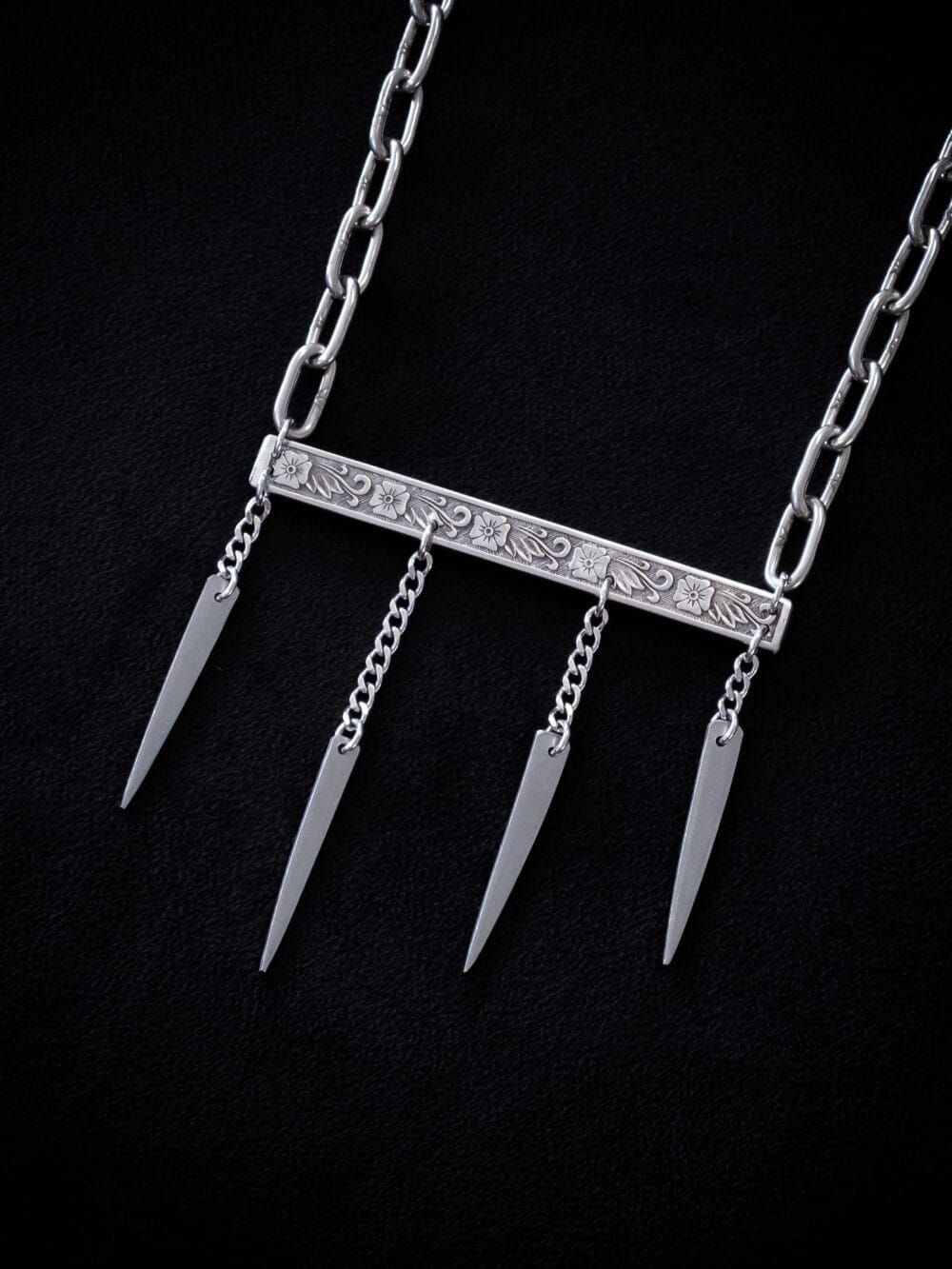 a stainless steel necklace made from the handle and fork tines of a vintage fork.