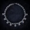 a necklace made from chunky stainless steel chain and hex nuts as charms along it.