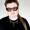 a woman with sunglasses and a black shirt on wearing a stainless steel curb chain necklace with fork tines as charms for a product photoshoot