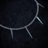 a stainless steel curb chain necklace with fork tines as charms