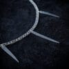 a stainless steel curb chain necklace with fork tines as charms