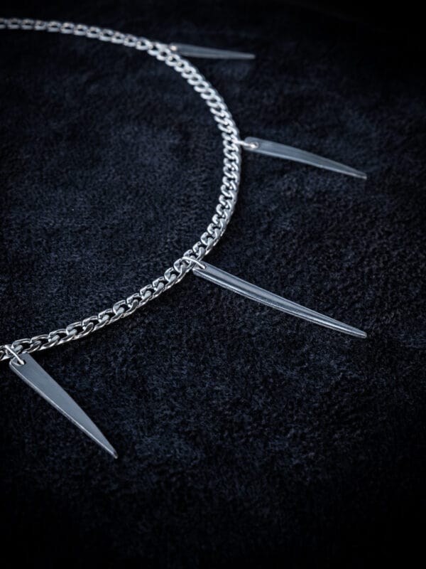 a stainless steel curb chain necklace with fork tines as charms