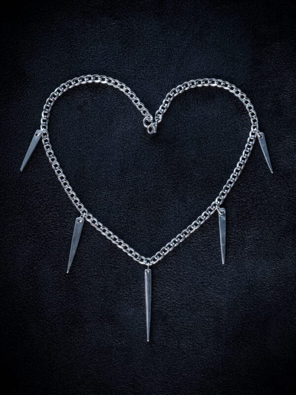 a stainless steel curb chain necklace with fork tines as charms