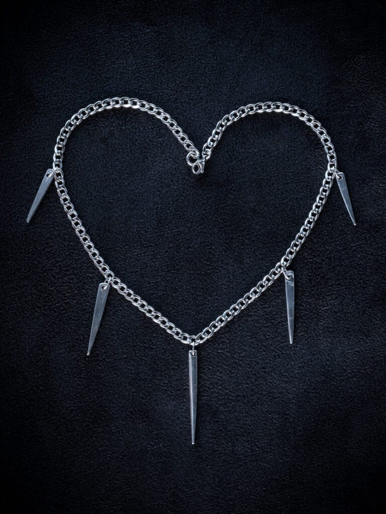a stainless steel curb chain necklace with fork tines as charms
